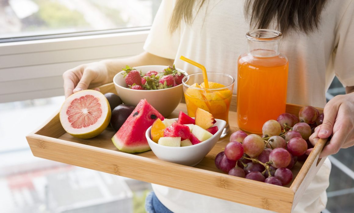 holding tray of fruits