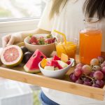 holding tray of fruits